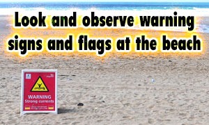 Look and observe warning signs and flags at the beach