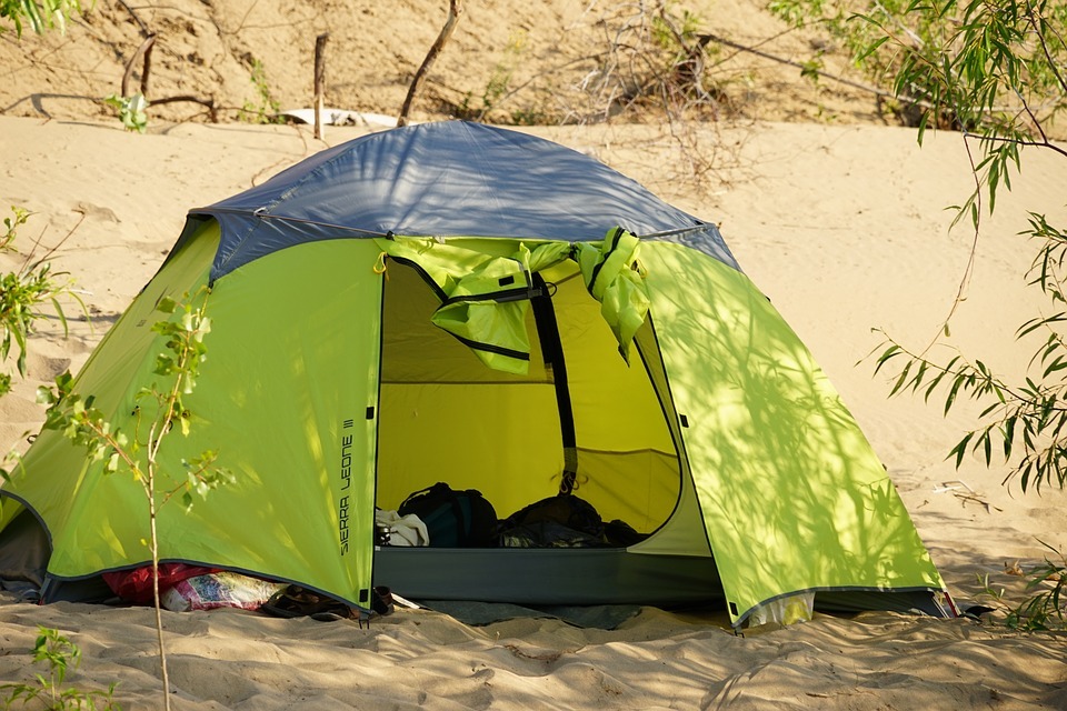 neon green beach tent in the sand
