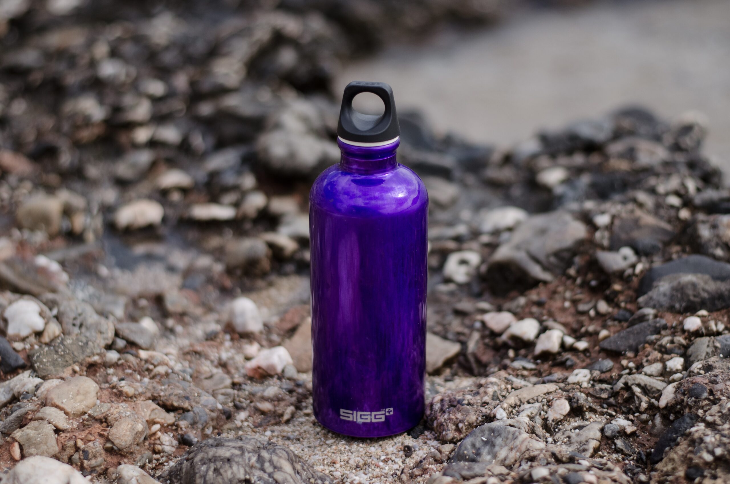 purple-sports-bottle-on-ground