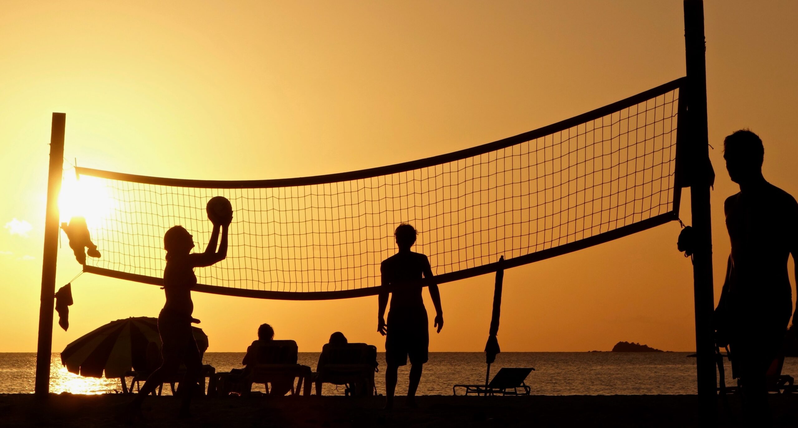 silhouette-photography-of-people-playing-beach-volleyball