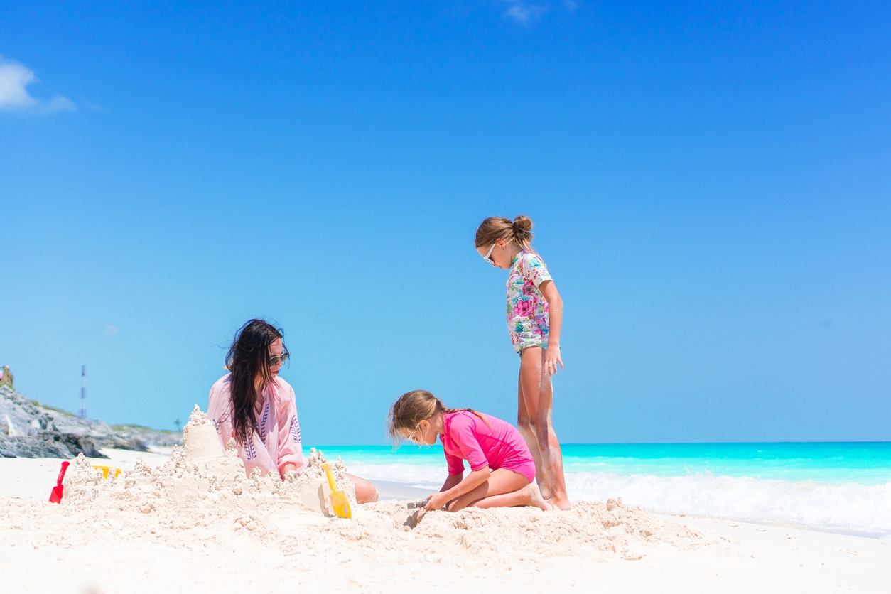 A family building sand castles on the beach