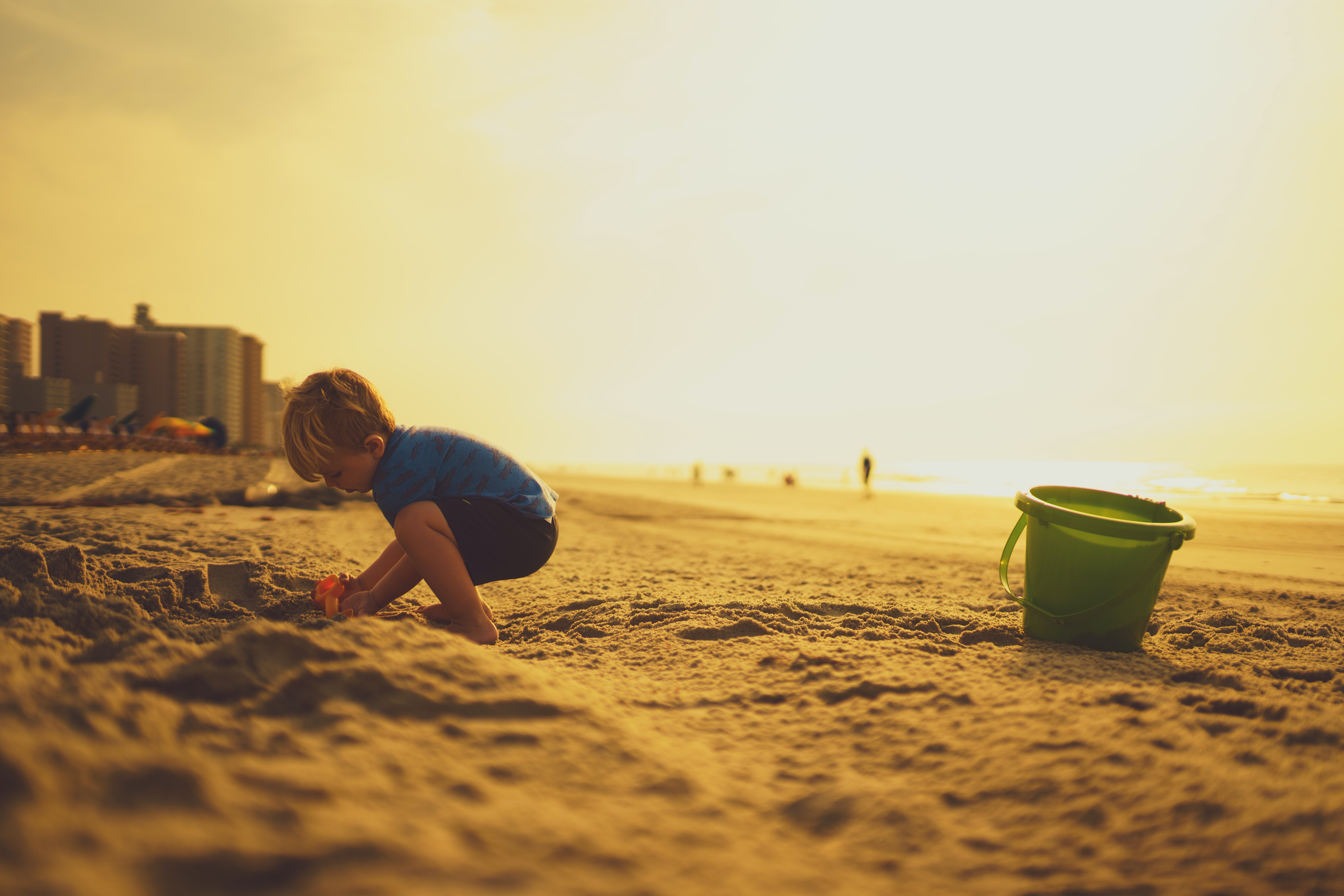 A young boy building sandcastles
